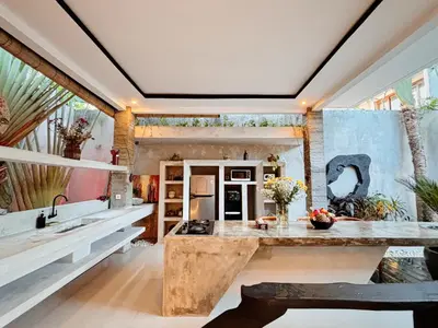 a kitchen with a large wooden island in a room at Modern 2 BR villa seminyak center. in Seminyak
