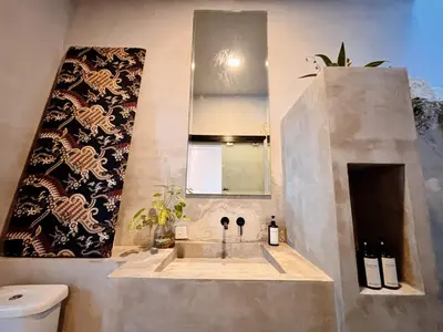 a bathroom with a sink and a mirror at Modern 2 BR villa seminyak center. in Seminyak