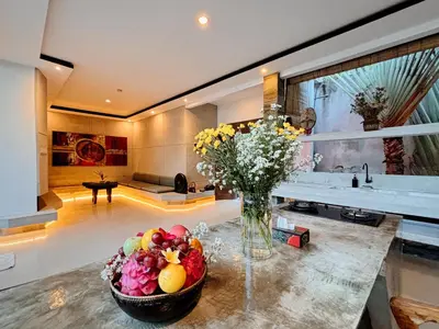 a vase of flowers on a counter in a kitchen at Modern 2 BR villa seminyak center. in Seminyak