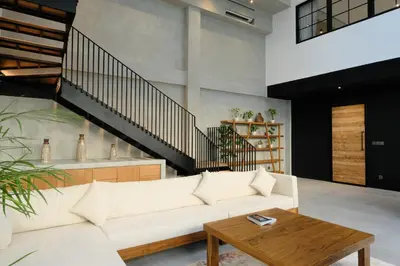 a living room with a white couch and a wooden table at Manresa Villa Bali 1 in Canggu