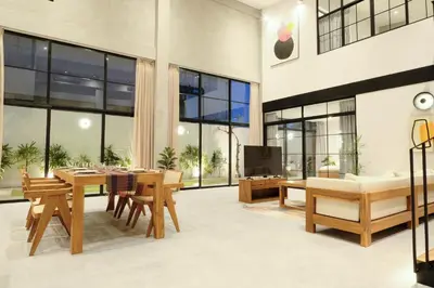 a living room with a table and chairs and a tv at Manresa Villa Bali 1 in Canggu
