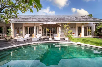 a swimming pool in front of a house at Villa Armani Seminyak in Seminyak