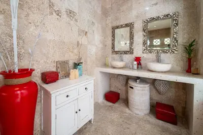 a bathroom with two sinks and a red vase at Villa Armani Seminyak in Seminyak
