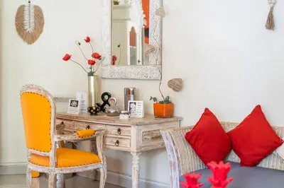a room with a table and chairs and a mirror at Villa Armani Seminyak in Seminyak