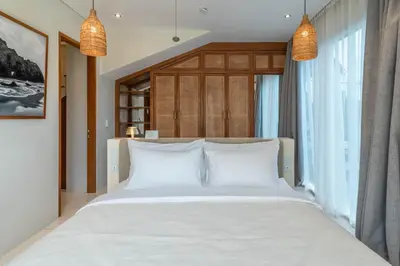 a bedroom with a large bed with white pillows at Alegria de la Vida in Canggu