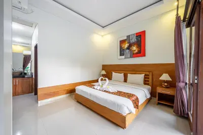 a bedroom with a large bed in a room at De Gani in Seminyak