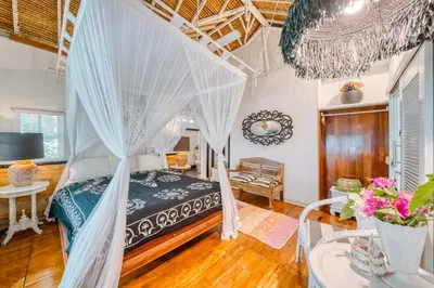 a bedroom with a canopy bed in a room at Villa Kalis, 10 BR family and group Villa in Seminyak