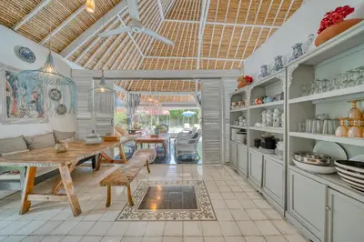 a kitchen with a table and a dining room at Villa Kalis, 10 BR family and group Villa in Seminyak