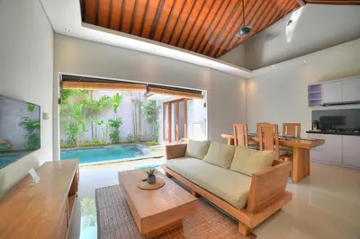 a living room with a couch and a table at Villa Laksmi Legian in Seminyak