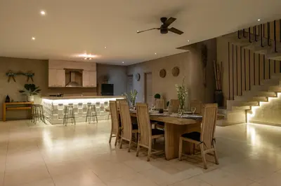 a kitchen and dining room with a table and chairs at Spacious and Stylish Villa 3 Bedroom Seminyak in Denpasar