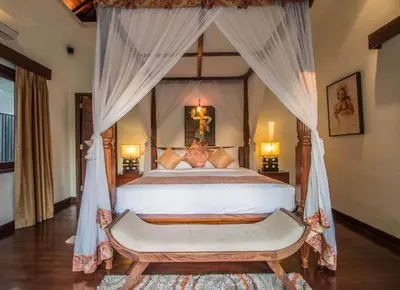 a bedroom with a large bed with a canopy at Beautiful & Luxurious 3-Bedroom Private Villa With Pool 150-Metres To Seminyak Beach in Seminyak