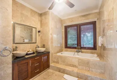 a bathroom with two sinks and a tub and a window at Beautiful & Luxurious 3-Bedroom Private Villa With Pool 150-Metres To Seminyak Beach in Seminyak