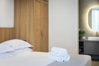 a bedroom with a bed with towels on it at 20 Suites Umalas in Canggu