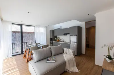 a living room with a couch and a kitchen at 20 Suites Umalas in Canggu
