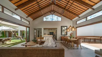 an open living room with a couch and a table at Villa Emmy by Elite Havens in Seminyak