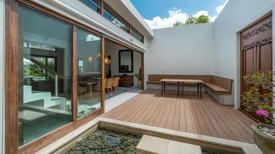 an external view of a house with a deck and a table at Villa Emmy by Elite Havens in Seminyak