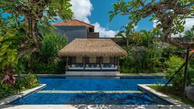a swimming pool with a gazebo in a garden at Villa Emmy by Elite Havens in Seminyak