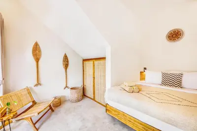 a bedroom with a bed and a chair at NEW Fresh 3BD Prime Location Villa in Seminyak
