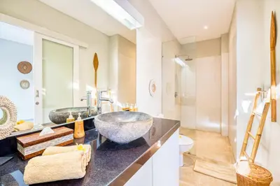 a bathroom with two sinks and a toilet at PROMO 3BD Tropical Villa in Central Umalas in Canggu