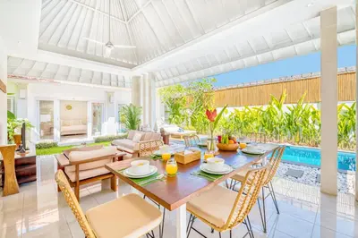a dining room with a table and chairs and a pool at PROMO 3BD Tropical Villa in Central Umalas in Canggu