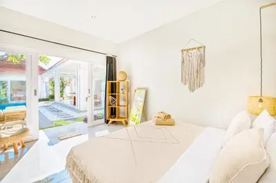 a white bedroom with a bed and a patio at PROMO 3BD Tropical Villa in Central Umalas in Canggu