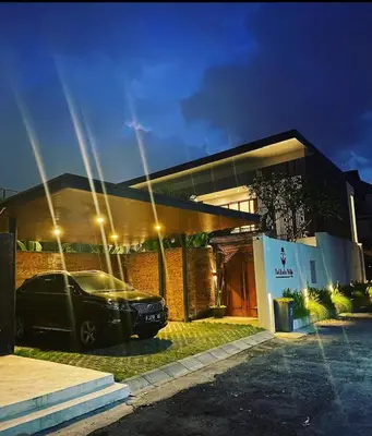 a car parked in front of a house at night at Tatkala Villa Seminyak in Seminyak