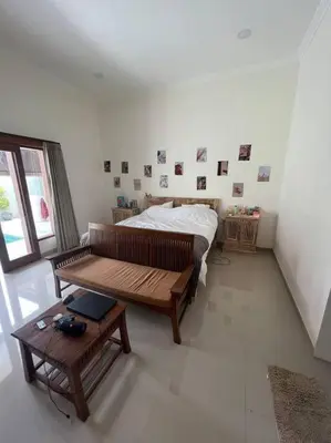 a bedroom with a bed and a bench and a table at Villa Keane Bali 2 BR, Private Pool in Seminyak