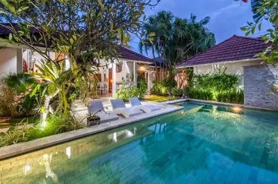 a villa with a swimming pool at night at Villa Fendi Seminyak in Seminyak
