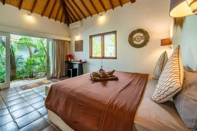 a bedroom with a large bed in a room at Villa Fendi Seminyak in Seminyak