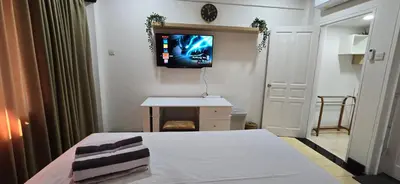 a room with a bed and a tv on the wall at The Palmana Tropical Roofline Jayakarta Residence 50 in Legian