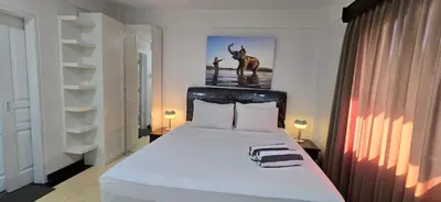 a bedroom with a large white bed in a room at The Palmana Tropical Roofline Jayakarta Residence 50 in Legian