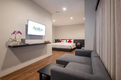 a living room with a couch and a bed at Aralea Coliving in Denpasar