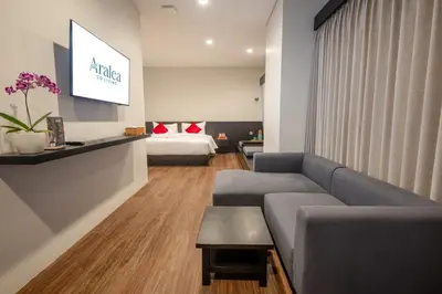 a living room with a couch and a bed at Aralea Coliving in Denpasar