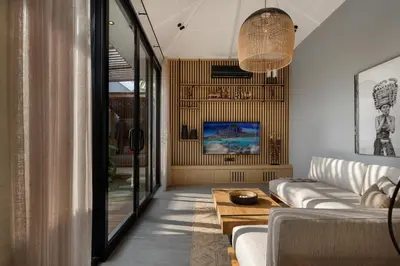 a living room with a couch and a table at Ananda Villa by Betterplace in Jimbaran