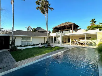a house with a swimming pool in front of a house at VILLA CELAVI 15 in Kerobokan