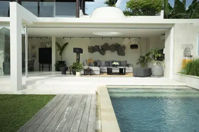 a house with a swimming pool and a living room at VILLA CELAVI 15 in Kerobokan
