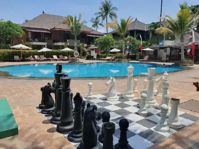 a chess board in front of a pool at The Palmana Courtyard Jayakarta Residence 2 in Seminyak
