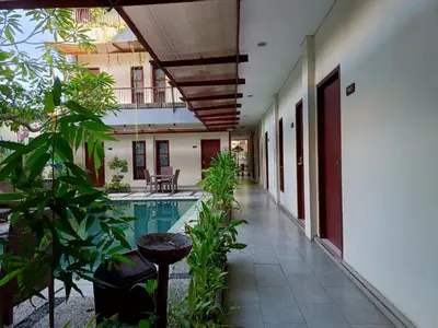 a courtyard of a house with a swimming pool at Keola Hotel Legian in Legian