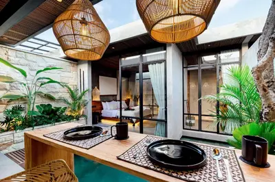 a room with a table with two black plates on it at Danu Villas Bali in Kerobokan