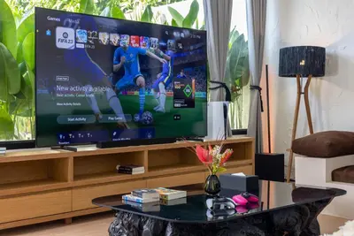 a living room with a tv and a coffee table at Villa Matahari - Seminyak in Seminyak