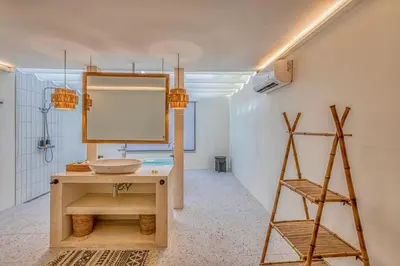 a bathroom with a sink and a mirror at Villa Matahari - Seminyak in Seminyak
