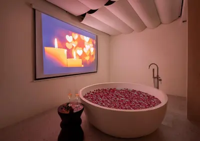 a bathroom with a large bath tub with a painting at Villa Matahari - Seminyak in Seminyak