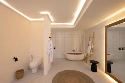 a bathroom with a tub and a toilet and a sink at Villa Matahari - Seminyak in Seminyak
