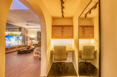 a living room with a table and two chairs at Villa Matahari - Seminyak in Seminyak
