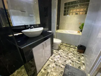 a bathroom with a sink and a toilet and a tub at Villa Mabuk in Legian