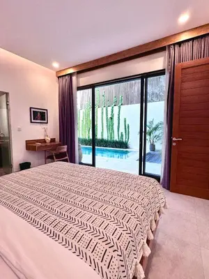 a bedroom with a large bed and a large window at LINDT - Bali Invest Club in Dalung
