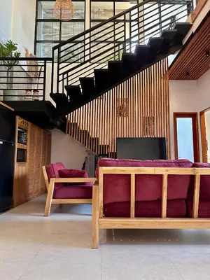 a living room with a couch and a table at LINDT - Bali Invest Club in Dalung