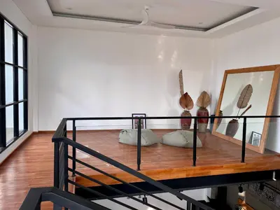 a loft bed with pillows on it in a room at LINDT - Bali Invest Club in Dalung