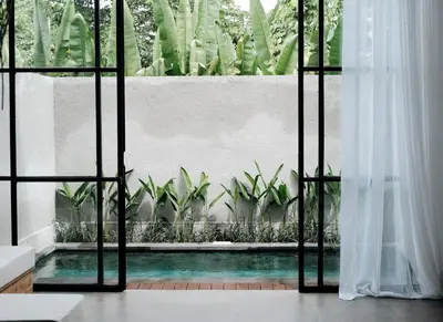 a view of a pool from a room with a window at TropicalLoft With Ocean View From Rooftop -RARE! in Canggu