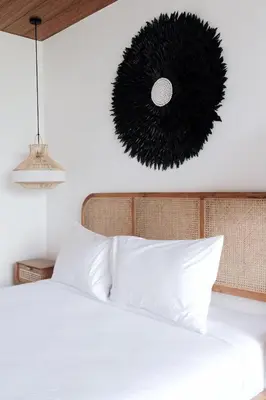 a bedroom with a bed with white pillows and a black pendant at TropicalLoft With Ocean View From Rooftop -RARE! in Canggu